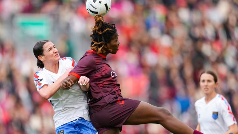 Montreal Roses FC Defender Lucy Cappadona and AFC Toronto forward Esther Okoronkwo jump for the ball during second half Northern Super League action in Toronto on Saturday, April 19, 2025. (THE CANADIAN PRESS/Arlyn McAdorey)