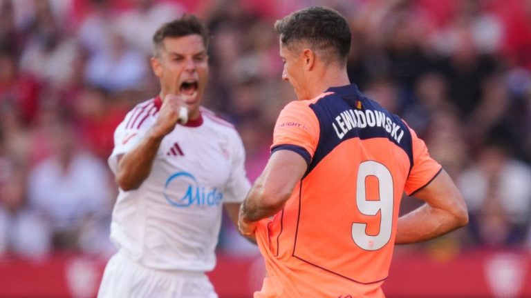 Sevilla's Cesar Azpilicueta, left, reacts after Barcelona's Robert Lewandowski, right, missed a scoring chance during the Spanish La Liga soccer match between Sevilla and Barcelona at the Ramon Sanchez Pizjuan stadium in Seville, Spain, Sunday, Oct. 5, 2025. (Jose Breton/AP)