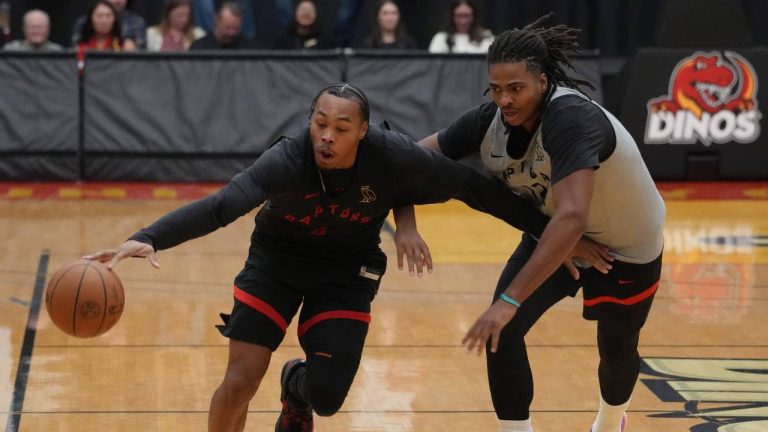 Toronto Raptors' Scottie Barnes, left, and Collin Murray-Boyles battle for the ball during training camp in Calgary on Friday, October 3, 2025. (Todd Korol/CP)