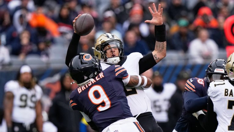 New Orleans Saints quarterback Spencer Rattler is sacked by Chicago Bears safety Jaquan Brisker (9) in the first half of an NFL football game, Sunday, Oct. 19, 2025, in Chicago. (AP Photo/Nam Huh)