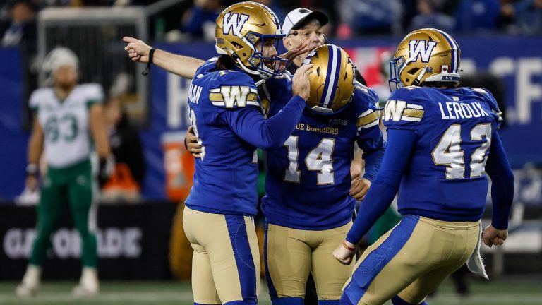 Winnipeg Blue Bombers' Jamieson Sheahan (18), kicker Sergio Castillo (14) and Ian Leroux (42) celebrate Castillo's game-winning field goal against the Saskatchewan Roughriders during second half CFL action in Winnipeg Friday, October 17, 2025. (John Woods/CP)