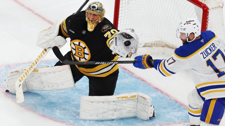 Boston Bruins' Joonas Korpisalo (70) makes the save as Buffalo Sabres' Jason Zucker (17) fails to deflect the shot during the second period of an NHL hockey game, Thursday, Oct. 30, 2025, in Boston. (AP Photo/Michael Dwyer)