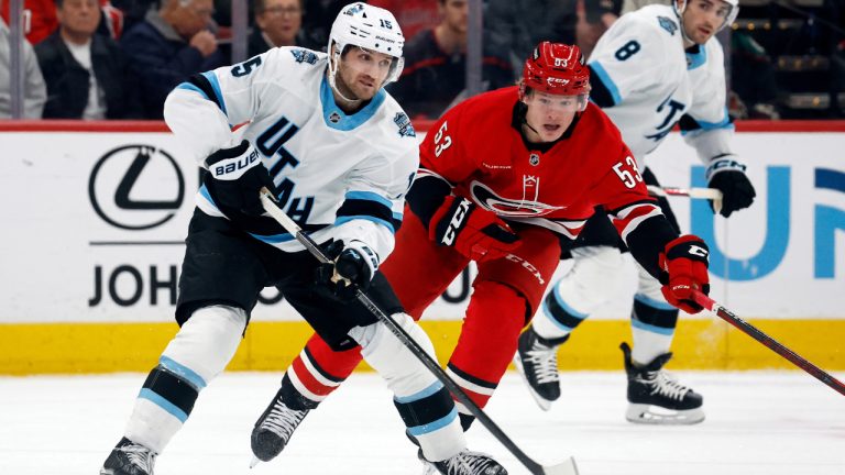 Utah's Alex Kerfoot moves the puck in front of Carolina Hurricanes' Jackson Blake during the first period of an NHL game in Raleigh, N.C., Saturday, Feb. 8, 2025. (Karl DeBlaker/AP)