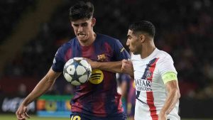 Barcelona's Gerard Martin challenges for the ball with PSG's Achraf Hakimi during the Champions League opening phase soccer match between Barcelona and Paris Saint-Germain at the Lluis Companys Olympic Stadium in Barcelona, Spain, Wednesday, Oct. 1, 2025. (Emilio Morenatti/AP)