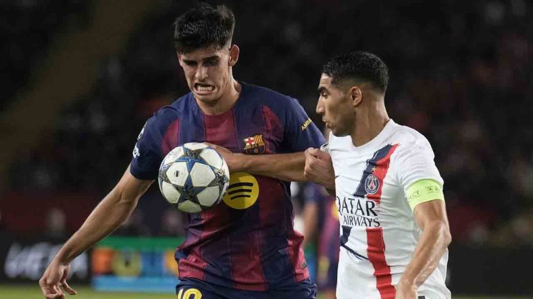 Barcelona's Gerard Martin challenges for the ball with PSG's Achraf Hakimi during the Champions League opening phase soccer match between Barcelona and Paris Saint-Germain at the Lluis Companys Olympic Stadium in Barcelona, Spain, Wednesday, Oct.1, 2025. (Emilio Morenatti/AP)