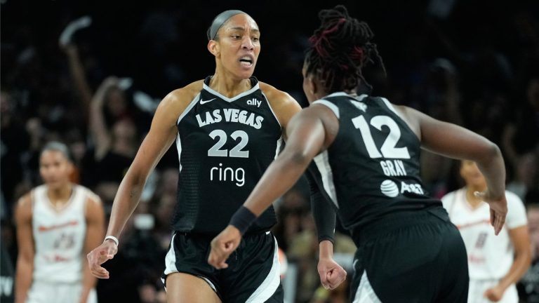 Las Vegas Aces center A'ja Wilson (22) and guard Chelsea Gray (12) celebrate during the first half in Game 2 of the WNBA basketball finals against the Phoenix Mercury, Sunday, Oct. 5, 2025, in Las Vegas. (AP Photo/John Locher)