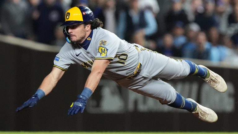 Milwaukee Brewers' Sal Frelick dives to reach second base after hitting a double during the fifth inning of Game 4 in the National League Division Series against the Chicago Cubs Thursday, Oct. 9, 2025, in Chicago. (Nam Y. Huh/AP)