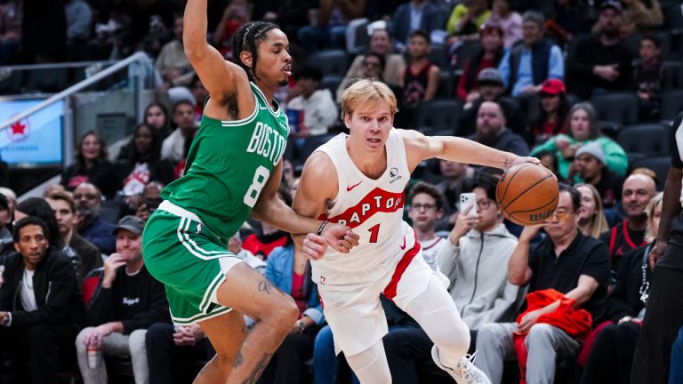 Toronto Raptors guard Gradey Dick drives past Boston Celtics forward Josh Minott during the first half of pre-season NBA action in Toronto Friday, October 10, 2025. (Thomas Skrlj/CP)