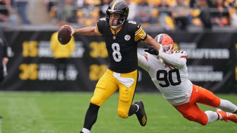 Pittsburgh Steelers quarterback Aaron Rodgers (8) avoids a tackle by Cleveland Browns defensive end Joe Tryon-Shoyinka (90) in the first half of an NFL football game in Pittsburgh, Sunday, Oct. 12, 2025. (AP Photo/Gene J. Puskar)