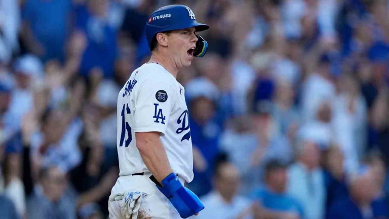 Los Angeles Dodgers' Tommy Edman celebrates after his RBI-single against the Milwaukee Brewers during the sixth inning in Game 3 of baseball's National League Championship Series, Thursday, Oct. 16, 2025, in Los Angeles. (Brynn Anderson/AP)