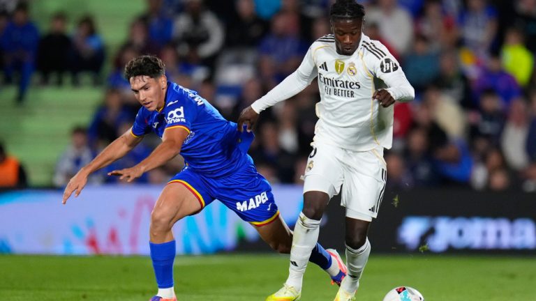 Getafe's Mario Martin, lrft and Real Madrid's Eduardo Camavinga run for the ball during a La Liga match between Getafe and Real Madrid in Getafe, Spain, Sunday, Oct. 19, 2025. (Manu Fernandez/AP)