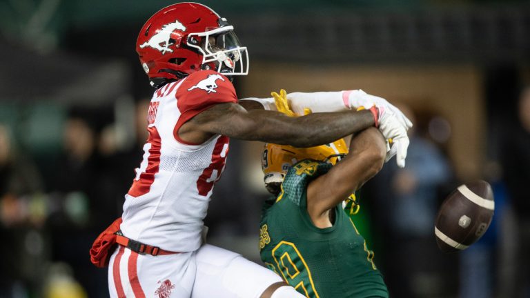 Calgary Stampeders' Damien Alford knocks the ball away from Edmonton Elks' JJ Ross during first half CFL action in Edmonton, on Friday October 24, 2025. (Jason Franson/CP)
