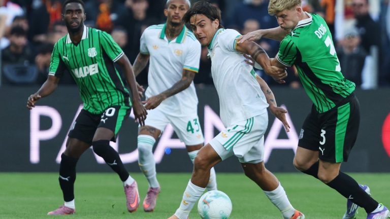 Roma's Paulo Dybala is challenged by Sassuolo's Josh Doig, right, during the Serie A soccer match between Sassuolo and Roma, in Reggio Emilia, Italy, Sunday, Oct. 26, 2025. (Gianni Santandrea/LaPresse via AP)