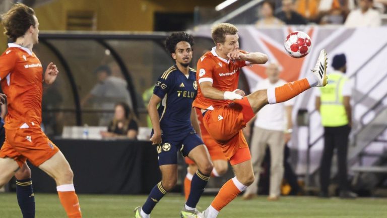 Forge FC's Daniel Nimick (right) tries to settle down a ball with pressure from Vancouver Whitecaps' Jeevan Singh Badwal (59) during second half Canadian Championship semifinal soccer action in Hamilton, on Thursday, August 13, 2025. (Nick Iwanyshyn/CP)