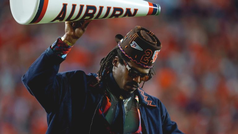 Former Auburn quarterback and NFL player Cam Newton reacts after a play during the first half of an NCAA college football game against Georgia, Saturday, Oct. 11, 2025, in Auburn, Ala. (AP Photo/Butch Dill)