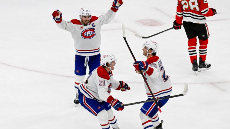 Montreal Canadiens' Kaiden Guhle (21) celebrates with Nick Suzuki (14) and Juraj Slafkovský (20) after scoring a goal during the third period of an NHL hockey game against the Chicago Blackhawks, Saturday, Oct. 11, 2025, in Chicago. (Matt Marton/AP)
