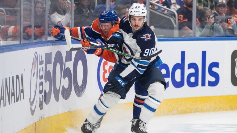 Winnipeg Jets' Nikita Chibrikov (90) checks Edmonton Oilers' James Hamblin (57) during first period NHL preseason action in Edmonton on Sunday September 24, 2023. (Jason Franson/CP)