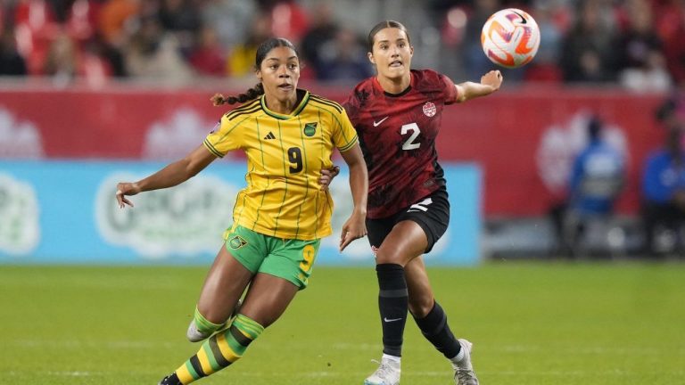 Canada's Sydney Collins battles Jamaica's Kameron Simmonds for the ball during first half Concacaf women's championship soccer series match in Toronto on Tuesday Sept. 26, 2023. (Nathan Denette/CP)