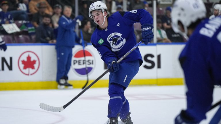 Vancouver Canucks' Braeden Cootes passes the puck during the opening day of the NHL hockey team's training camp, in Penticton, B.C., on Thursday, September 18, 2025. (Darryl Dyck/CP)