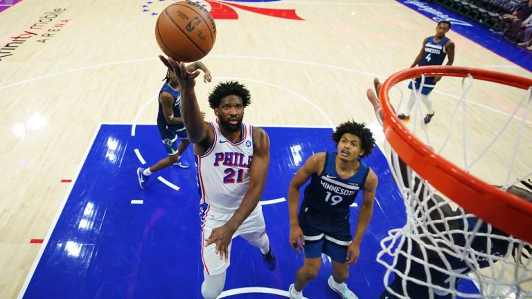 Philadelphia 76ers' Joel Embiid (21) goes up for a shot past Minnesota Timberwolves' Joan Beringer (19) during the first half of an preseason NBA basketball game Friday, Oct. 17, 2025, in Philadelphia. (Matt Slocum/AP)