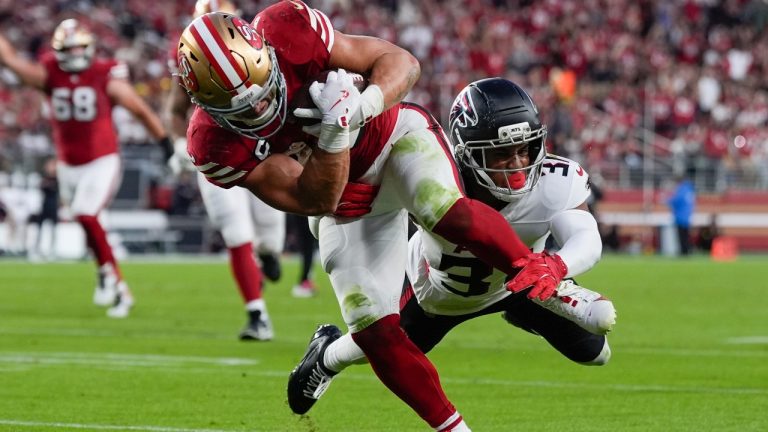 San Francisco 49ers running back Christian McCaffrey (23) runs against Atlanta Falcons safety Xavier Watts (31) in the first half of an NFL football game, Sunday, Oct. 19, 2025, in Santa Clara, Calif. (AP Photo/Godofredo A. Vásquez)