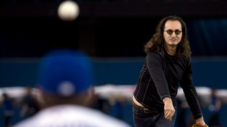 Geddy Lee from Rush thows out the first pitch prior to Toronto Blue Jays against Cleveland on the opening day baseball action in Toronto on Tuesday, April 2, 2013. (Nathan Denette/CP)