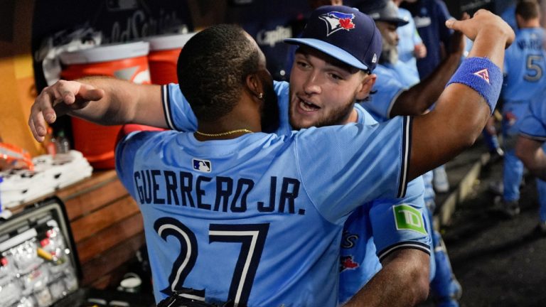Toronto Blue Jays pitcher Trey Yesavage hugs Vladimir Guerrero Jr. (27) in the dugout during the seventh inning in Game 5 of baseball's World Series against the Los Angeles Dodgers, Wednesday, Oct. 29, 2025, in Los Angeles. (Ashley Landis/AP)