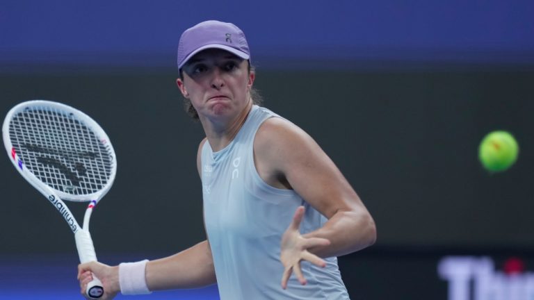 Iga Swiatek of Poland plays a forehand return to Emma Navarro, of the United States during the women's singles match for the China Open tennis tournament, in Beijing, China, Wednesday, Oct. 1, 2025. (AP/Mahesh Kumar A.)