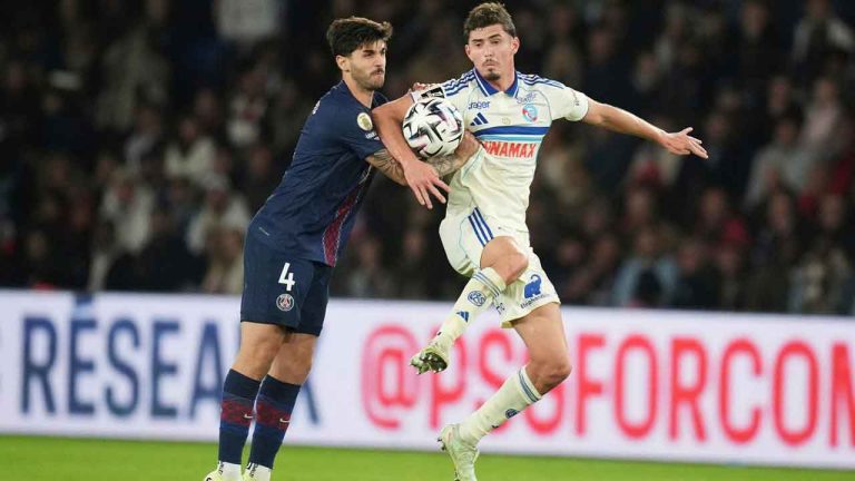 PSG's Lucas Beraldo, left, and Strasbourg's Joaquin Panichelli challenge for the ball during the French League One soccer match between Paris Saint-Germain and Strasbourg, in Paris. (Christophe Ena/AP)