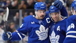 Toronto Maple Leafs centre John Tavares (91) celebrates his goal against the Buffalo Sabres with teammates Auston Matthews (34) and Morgan Rielly (44) during second period NHL hockey action in Toronto, Sunday, Dec. 15, 2024. (Frank Gunn/CP)