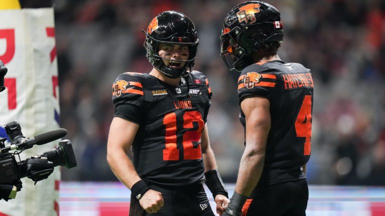 B.C. Lions quarterback Nathan Rourke (12) and Keon Hatcher (4) celebrate Hatcher's touchdown against the Edmonton Elks during the second half of a CFL football game, in Vancouver, on Friday, October 17, 2025. (Darryl Dyck/CP)