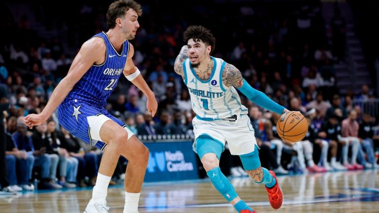 Charlotte Hornets guard LaMelo Ball (1) drives against Orlando Magic forward Franz Wagner, left, during the first half of an NBA basketball game in Charlotte, N.C., Thursday, Oct. 30, 2025. (AP Photo/Nell Redmond)