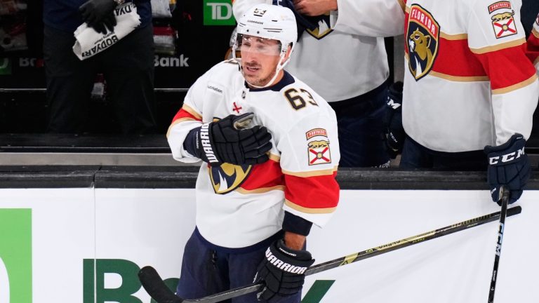 Florida Panthers left wing Brad Marchand, who played for more than 15 seasons with the Boston Bruins, taps his heart during a standing ovation during a break in the first period of an NHL game, Tuesday, Oct. 21, 2025, in Boston. (AP/Charles Krupa)