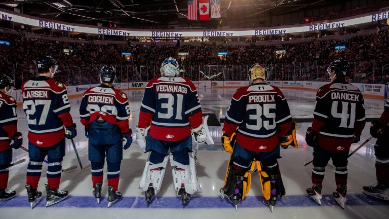 Newfoundland Regiment players stand along the blue line after player introductions before their Quebec Maritimes Junior Hockey League season opener at Mary Brown's Centre in St. John's in this Sept. 18, 2025 handout photo. (Jeff Parsons/HO via CP)
