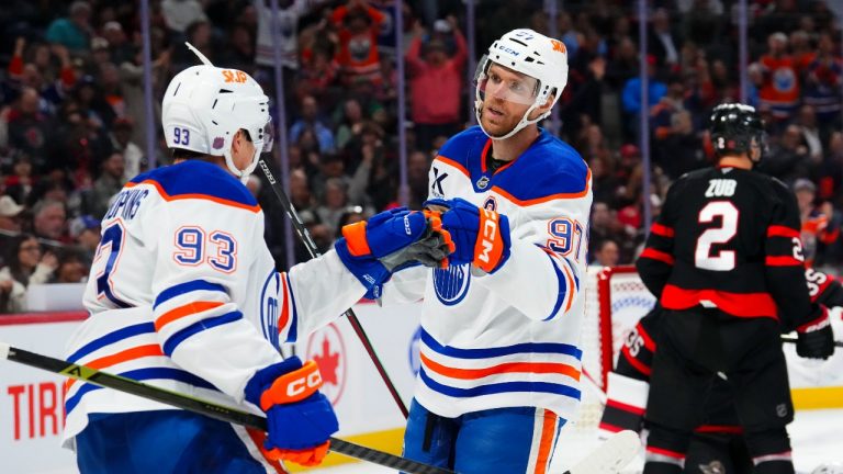 Edmonton Oilers' Connor McDavid (97) celebrates his goal with teammate Ryan Nugent-Hopkins (93) during first period NHL hockey action against the Ottawa Senators, in Ottawa on Tuesday, Oct. 21, 2025. THE CANADIAN PRESS/Sean Kilpatrick