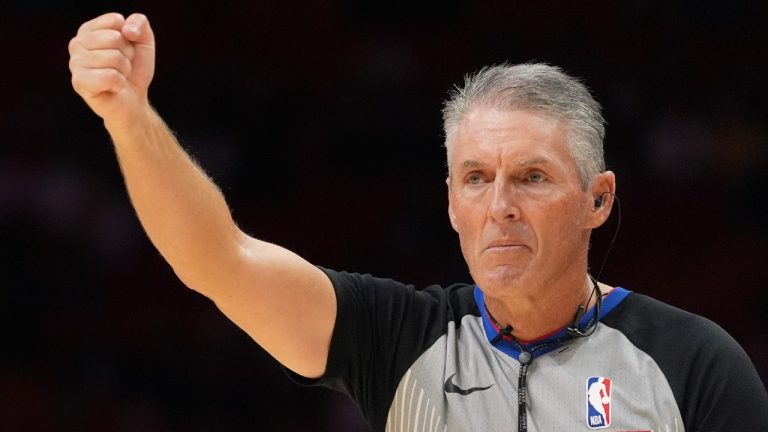 Referee Scott Foster, wearing an earpiece, signals a call during the second half of a preseason NBA basketball game between the Miami Heat and the Milwaukee Bucks, Monday, Oct. 6, 2025, in Miami. (Rebecca Blackwell/AP)