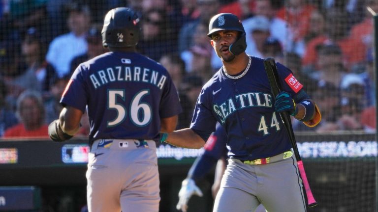 Seattle Mariners' Randy Arozarena (56) is congratulated by teammate Julio Rodríguez (44) after scoring during the fifth inning in Game 4 of baseball's American League Division Series against the Detroit Tigers, Oct. 8, 2025, in Detroit. (Ryan Sun/AP)