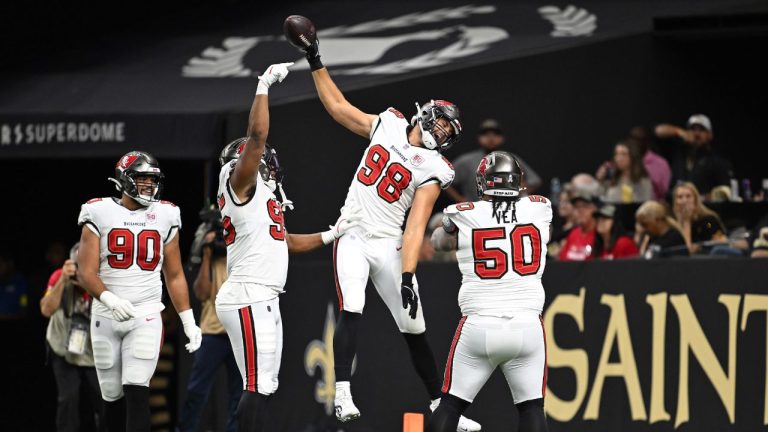 Tampa Bay Buccaneers linebacker Anthony Nelson celebrates with teammates after returning an interception for a score during the first half of an NFL game against the New Orleans Saints, Oct. 26, 2025. (Ella Hall/ AP)
