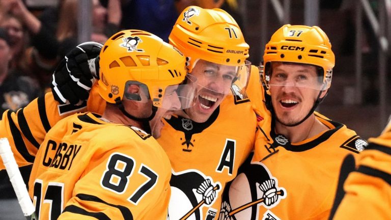Pittsburgh Penguins' Sidney Crosby (87) celebrates after his goal with Evgeni Malkin (71) and Rickard Rakell (67) during the second period of an NHL game against the New York Islanders in Pittsburgh, Thursday, Oct. 9, 2025. (Gene J. Puskar/ AP)
