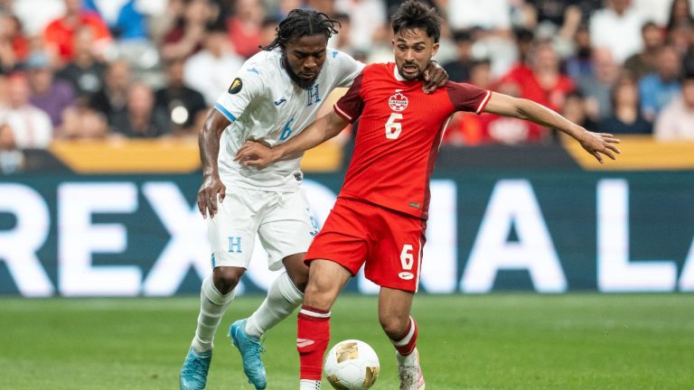 Honduras' Cristopher Melendez, left, and Canada's Mathieu Choiniere (6) vie for the ball during the first half of a CONCACAF Gold Cup soccer match in Vancouver, on Tuesday, June 17, 2025. (Ethan Cairns/ CP)