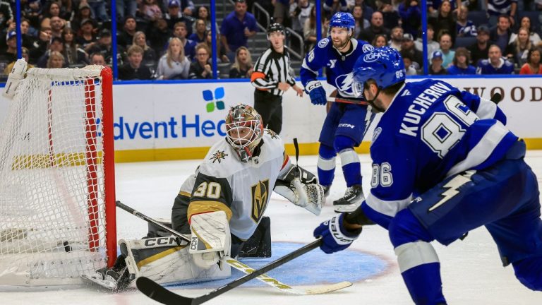 Tampa Bay Lightning's Nikita Kucherov, right, scores against Vegas Golden Knights goaltender Carl Lindbom, left, during the overtime period of an NHL hockey game, Oct. 26, 2025, in Tampa, Fla. (Mike Carlson /AP)