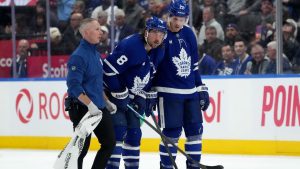 Toronto Maple Leafs defenceman Chris Tanev leaves the ice with an injury during second period NHL action against the New Jersey Devils, in Toronto, Tuesday, Oct. 21, 2025. (CP/Nathan Denette)