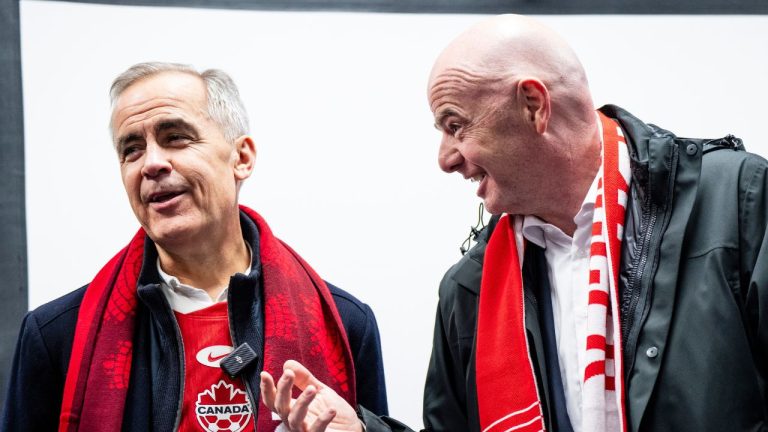 Prime Minister Mark Carney and FIFA President Gianni Infantino speak to Canada players following international friendly soccer action between Canada and Australia, in Montreal, on Friday, October 10, 2025. (Christopher Katsarov/CP)