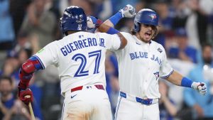 Addison Barger (right) celebrates after hitting a grand slam with Toronto Blue Jays teammate Vladimir Guerrero Jr. in Game 1 of the 2025 World Series. (Nathan Denette/CP)