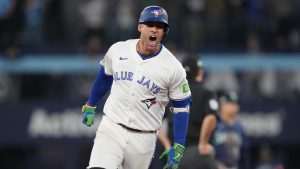 Toronto Blue Jays' George Springer (4) celebrates after hitting a three-run home run against the Seattle Mariners during seventh inning MLB American League Championship Series game 7 baseball action in Toronto, Monday, Oct. 20, 2025. (Nathan Denette/CP)