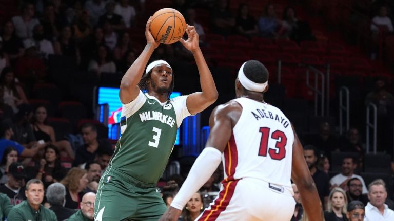 Milwaukee Bucks forward Myles Turner (3) looks for an opening past Miami Heat centre Bam Adebayo (13) during the first half of a preseason NBA basketball game, Monday, Oct. 6, 2025, in Miami. (Rebecca Blackwell/AP)