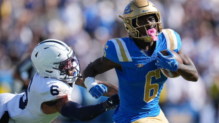 UCLA running back Anthony Woods (6) runs past Penn State safety Zakee Wheatley (6) during the second half of an NCAA college football game Saturday, Oct. 4, 2025, in Pasadena, Calif. (AP Photo/Marcio Jose Sanchez)