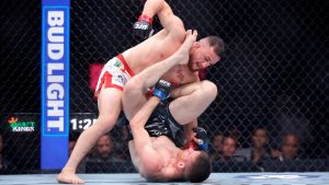 UFC bantamweight champion Merab Dvalishvili, top, fights with Cory Sandhagen at UFC 320 in Las Vegas. (Steve Marcus/Bay Area News Group via AP)