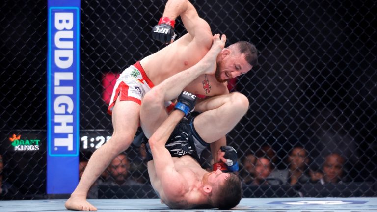 UFC bantamweight champion Merab Dvalishvili, top, fights with Cory Sandhagen at UFC 320 in Las Vegas. (Steve Marcus/Bay Area News Group via AP)
