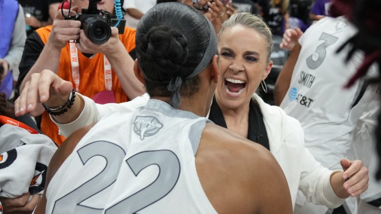 Las Vegas Aces head coach Becky Hammon, right, and A'ja Wilson (22) celebrate after defeating the Phoenix Mercury in Game 4 of the WNBA basketball finals, Friday, Oct. 10, 2025, in Phoenix. (Rick Scuteri/AP)